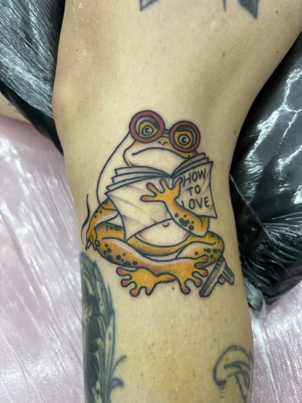 Tattoo by Myles Mokuahi, colorful cartoon frog, Hawaii
